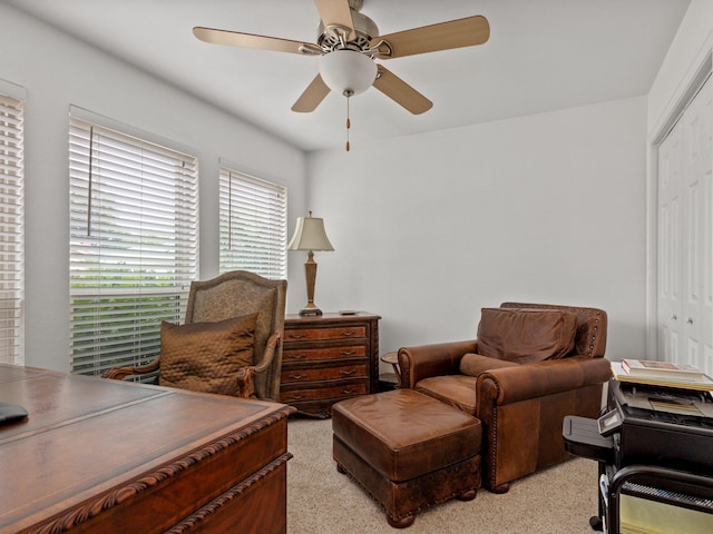 interior space featuring light colored carpet and ceiling fan