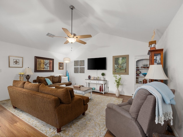 living area with vaulted ceiling, wood finished floors, visible vents, and a ceiling fan