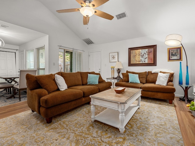 living room featuring ceiling fan, high vaulted ceiling, wood finished floors, and visible vents