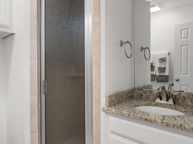 full bathroom featuring a shower stall and vanity