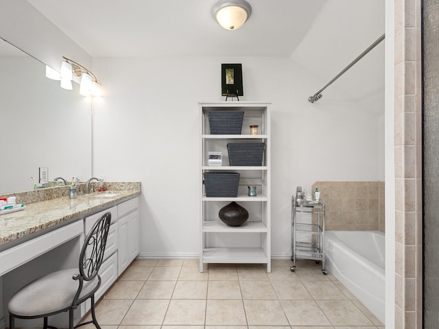 full bath with baseboards, vanity, a bath, and tile patterned floors