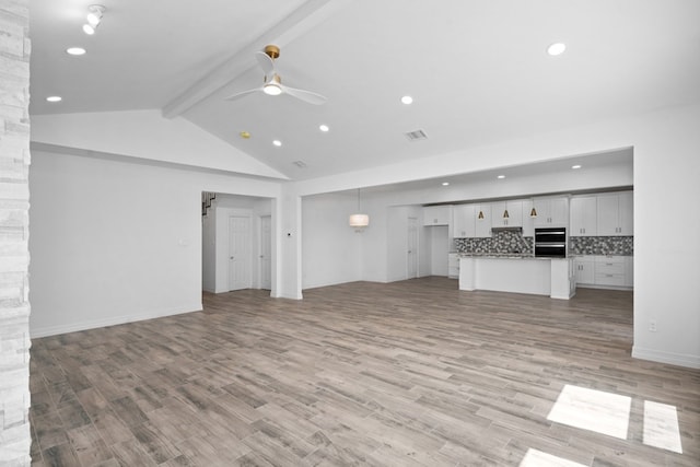 unfurnished living room featuring beam ceiling, light hardwood / wood-style flooring, high vaulted ceiling, and ceiling fan