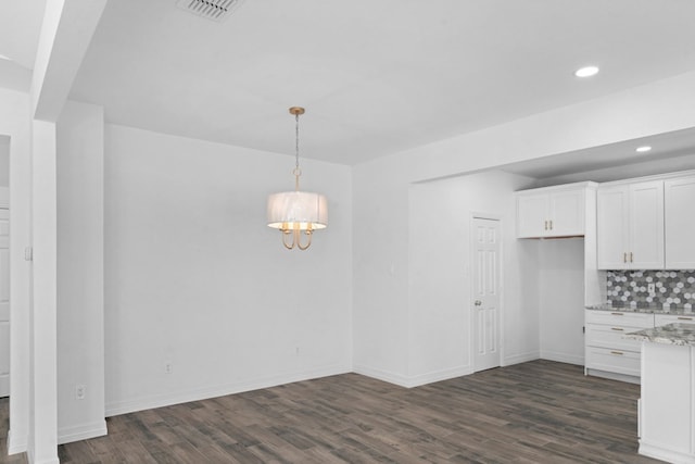 unfurnished dining area with dark wood-type flooring