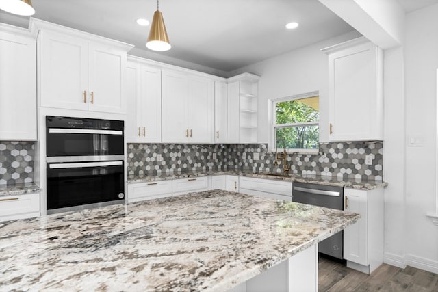 kitchen with double wall oven, dishwasher, hanging light fixtures, white cabinetry, and decorative backsplash