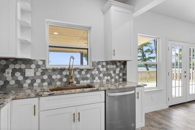 kitchen with tasteful backsplash, sink, stainless steel dishwasher, and plenty of natural light