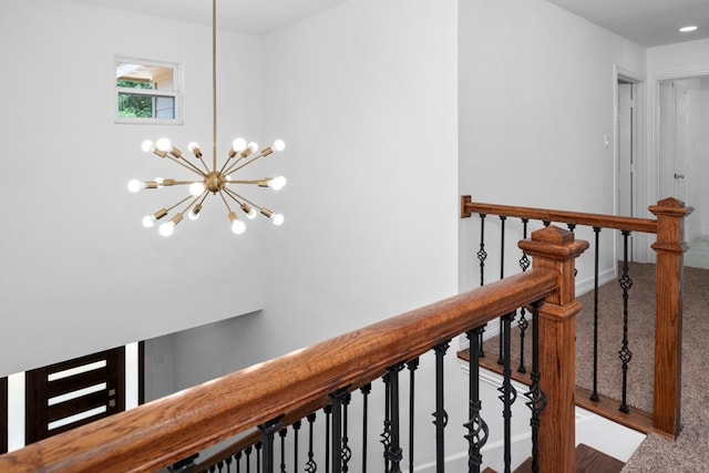 hall featuring carpet and an inviting chandelier