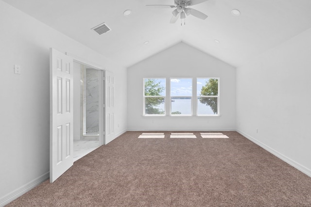 unfurnished bedroom featuring ceiling fan, lofted ceiling, and carpet floors