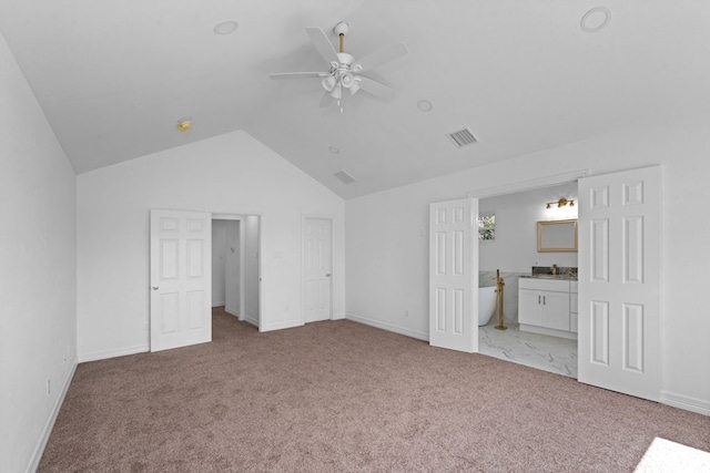 interior space featuring ensuite bathroom, high vaulted ceiling, carpet floors, and ceiling fan