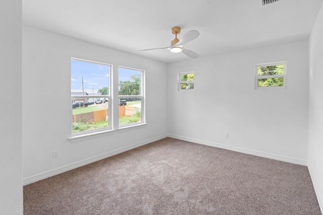 carpeted spare room with ceiling fan