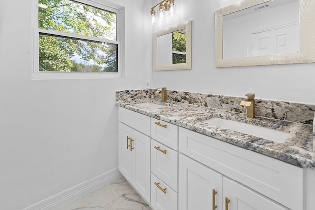 bathroom with tile patterned floors and double sink vanity