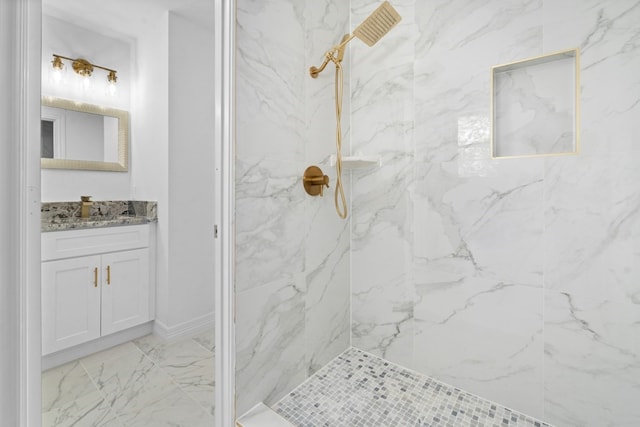 bathroom with tile patterned floors, a tile shower, and vanity