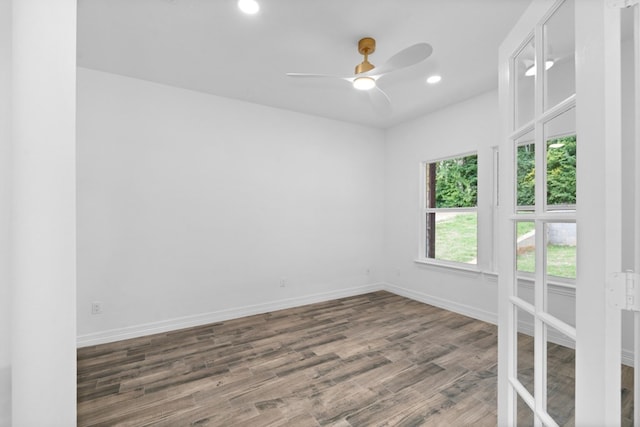 empty room featuring ceiling fan and hardwood / wood-style flooring