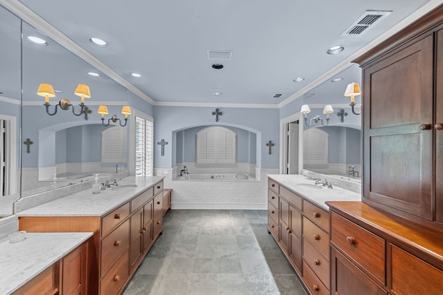 bathroom with vanity, crown molding, and tiled bath