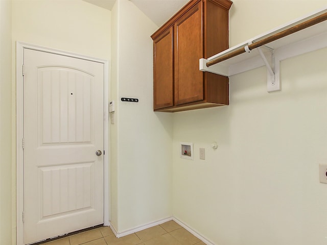 laundry area featuring light tile patterned flooring, cabinets, hookup for a gas dryer, and washer hookup