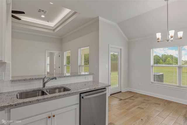 kitchen with light hardwood / wood-style floors, dishwasher, sink, and light stone counters