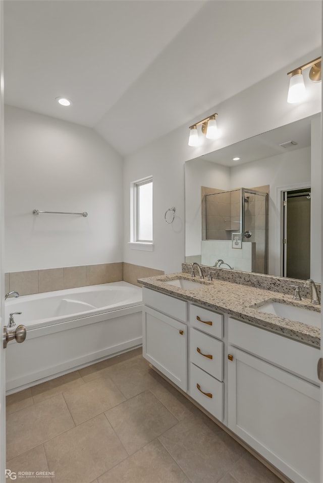 bathroom featuring shower with separate bathtub, tile patterned flooring, vanity, and lofted ceiling