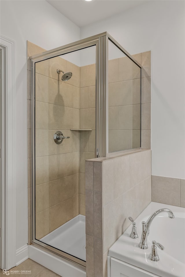 bathroom with shower with separate bathtub, tile patterned floors, and sink