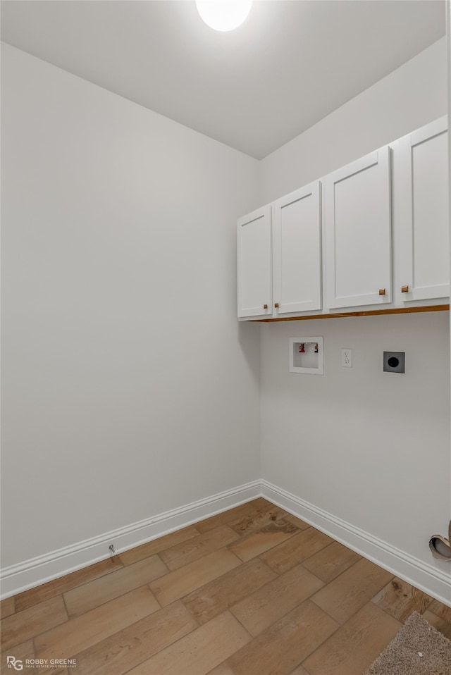 laundry area with washer hookup, cabinets, light wood-type flooring, and electric dryer hookup