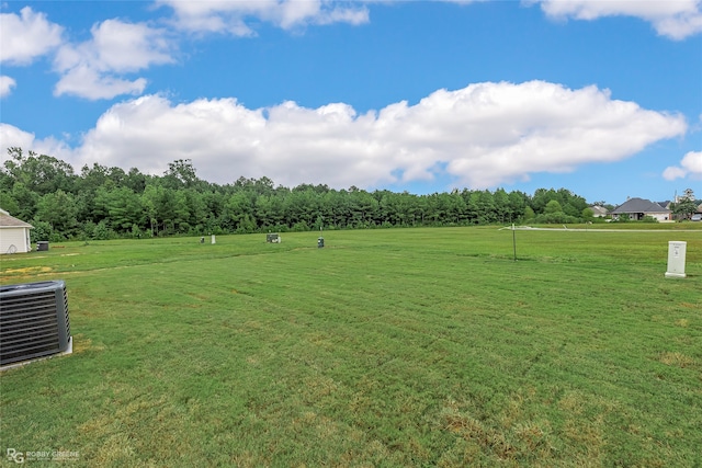 view of yard with cooling unit and a rural view