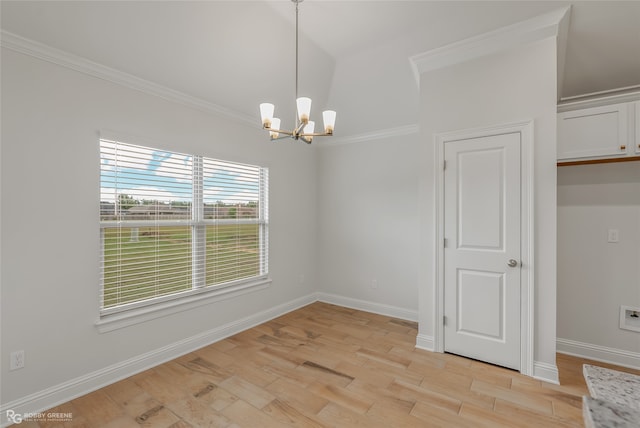 unfurnished dining area with light hardwood / wood-style floors, ornamental molding, and a notable chandelier