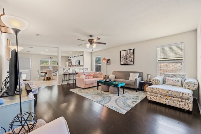 living room featuring hardwood / wood-style floors and ceiling fan