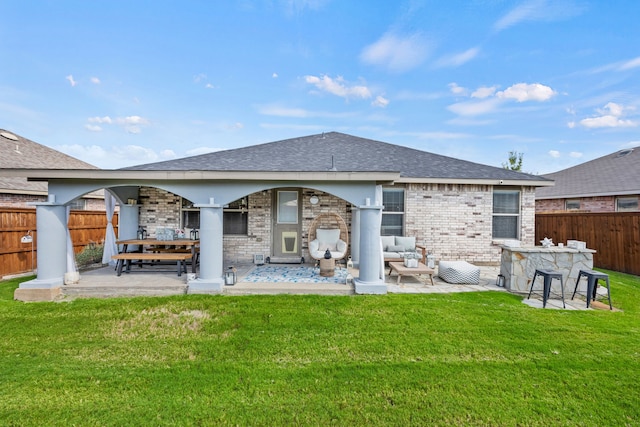 rear view of house featuring an outdoor living space, a yard, and a patio area