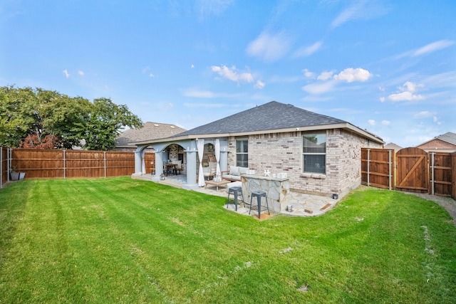 back of property featuring a lawn and a patio area