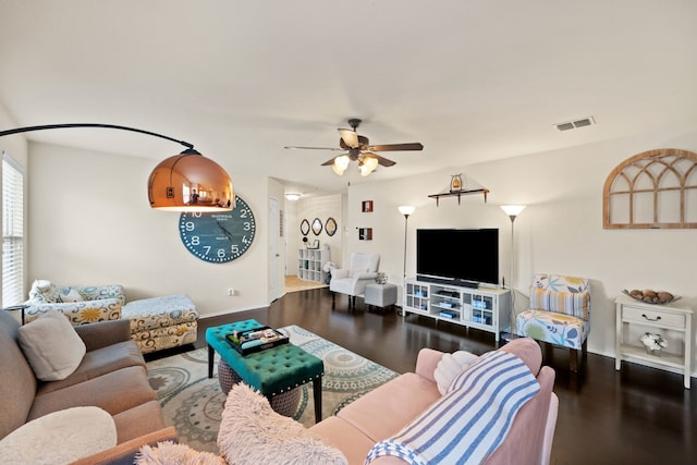 living room featuring wood-type flooring and ceiling fan