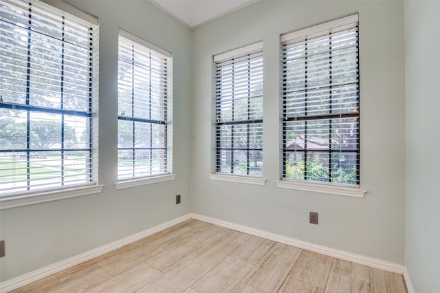 empty room with light wood-type flooring and a healthy amount of sunlight