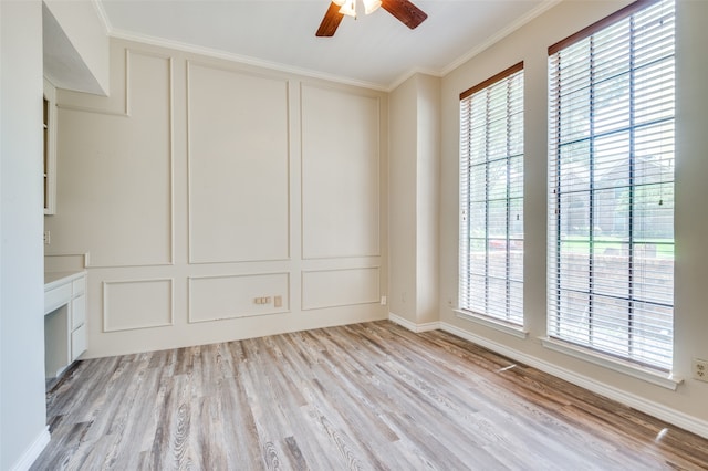 unfurnished room featuring light hardwood / wood-style floors, ceiling fan, plenty of natural light, and crown molding