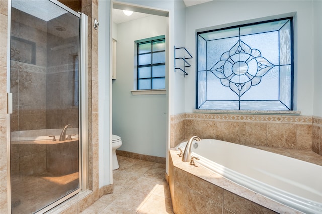 bathroom featuring separate shower and tub, tile patterned flooring, toilet, and a wealth of natural light