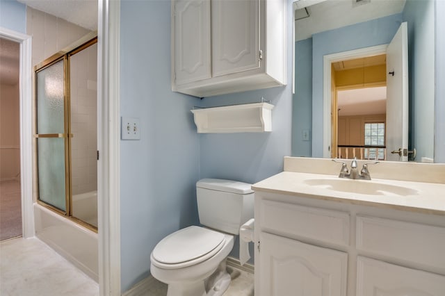 full bathroom with bath / shower combo with glass door, vanity, and toilet