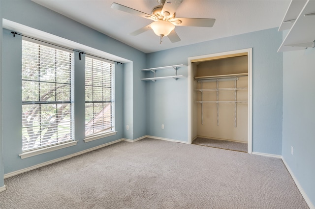 unfurnished bedroom featuring ceiling fan, a closet, and carpet flooring