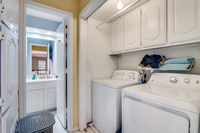 washroom featuring cabinets and independent washer and dryer