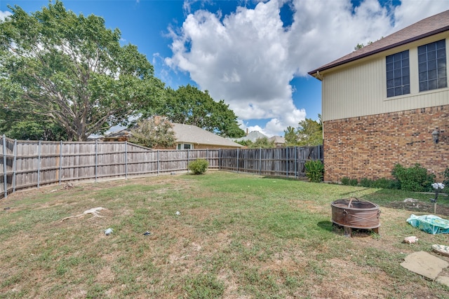 view of yard with a fire pit