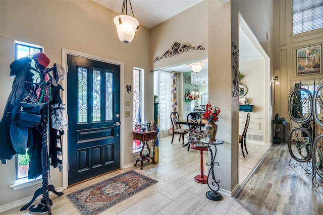 foyer with light hardwood / wood-style flooring and a wealth of natural light