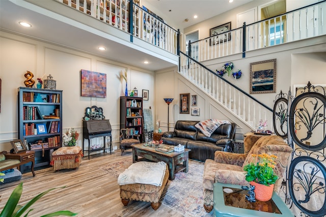 living room featuring a high ceiling and light wood-type flooring