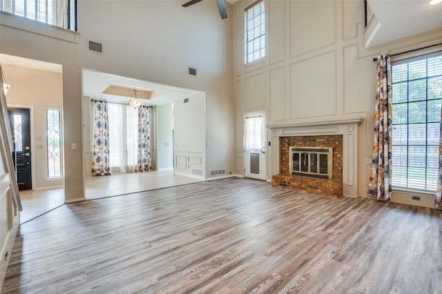 unfurnished living room with a wealth of natural light and a fireplace