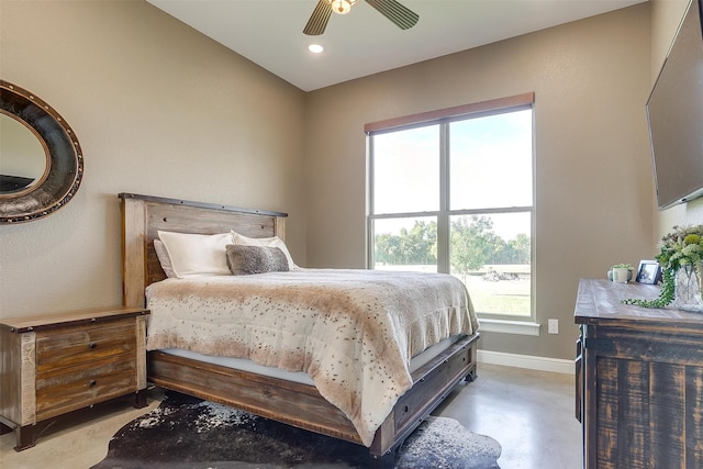 bedroom with ceiling fan and concrete floors