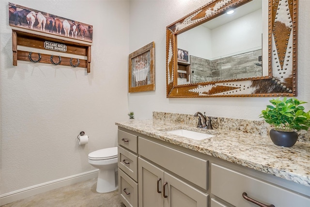 bathroom featuring walk in shower, vanity, and toilet