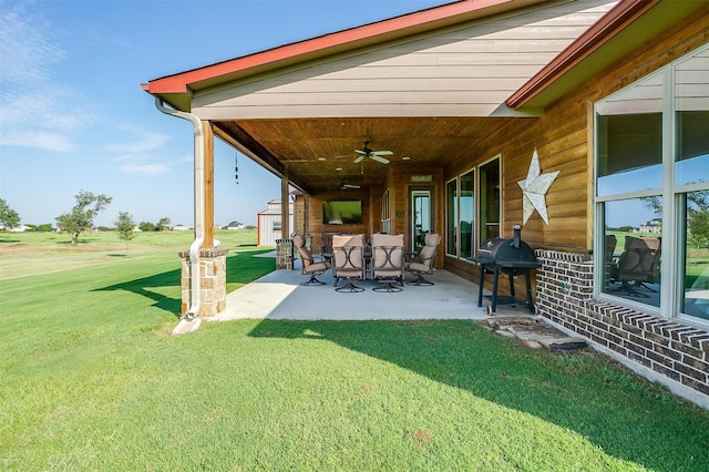 view of yard with ceiling fan and a patio