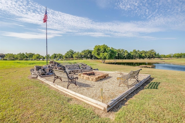 view of yard with a fire pit and a water view