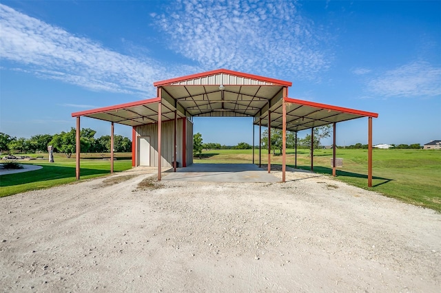 view of vehicle parking with a yard and a carport