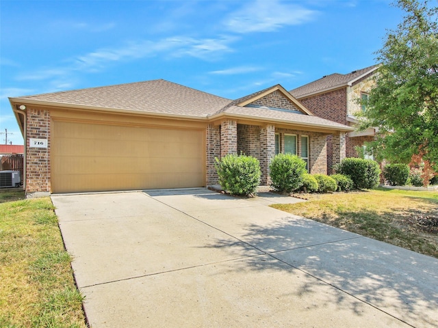 ranch-style house featuring a front yard, central air condition unit, and a garage