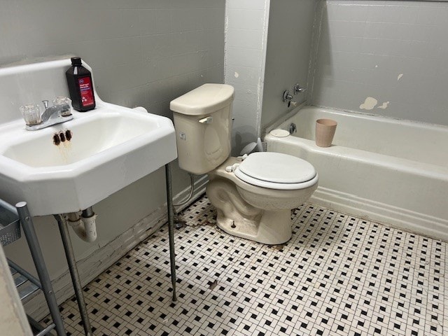 full bathroom with sink, shower / bathtub combination, toilet, and tile patterned flooring