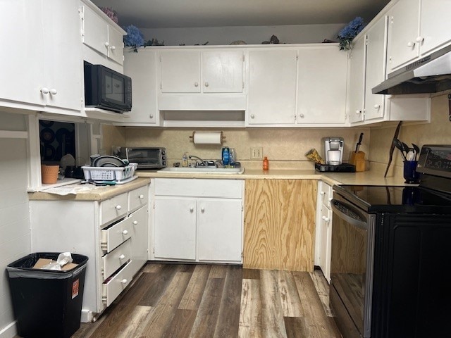 kitchen featuring black appliances, dark wood-type flooring, sink, and white cabinets