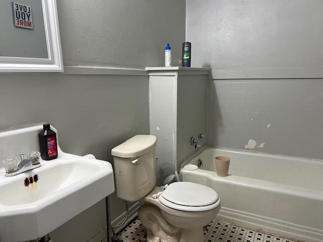 full bathroom featuring sink,  shower combination, toilet, and tile patterned flooring