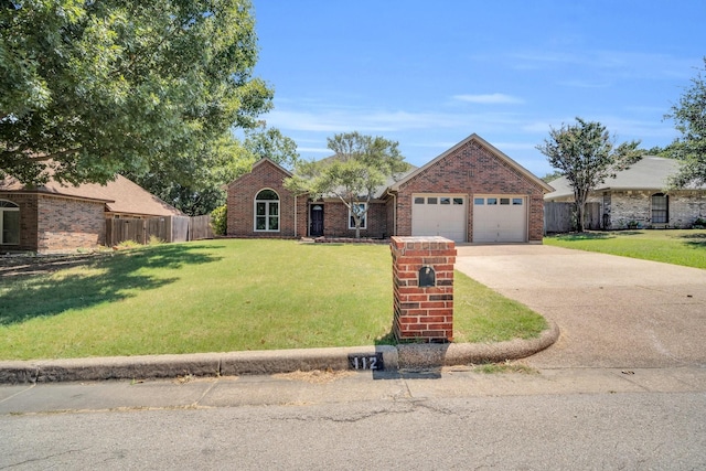 view of front of home with a garage and a front lawn