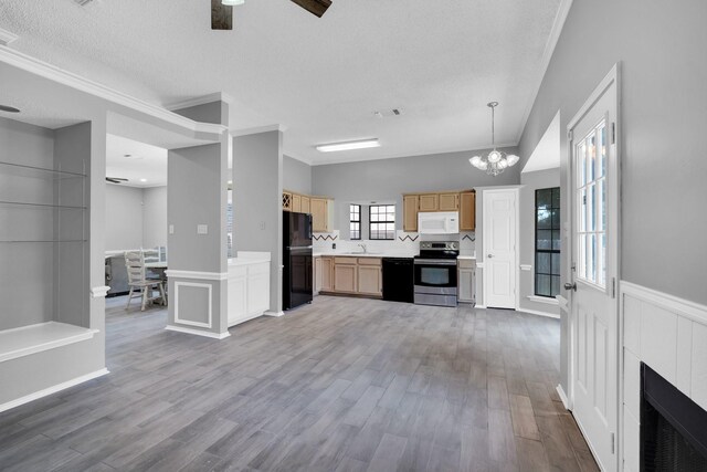 kitchen with light brown cabinets, ceiling fan with notable chandelier, wood finished floors, light countertops, and black appliances