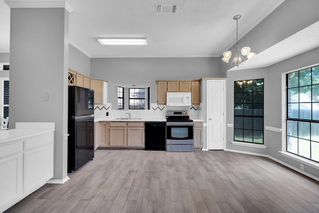 kitchen featuring light countertops, visible vents, light brown cabinetry, a sink, and black appliances